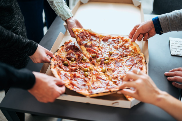 business people sharing pizza